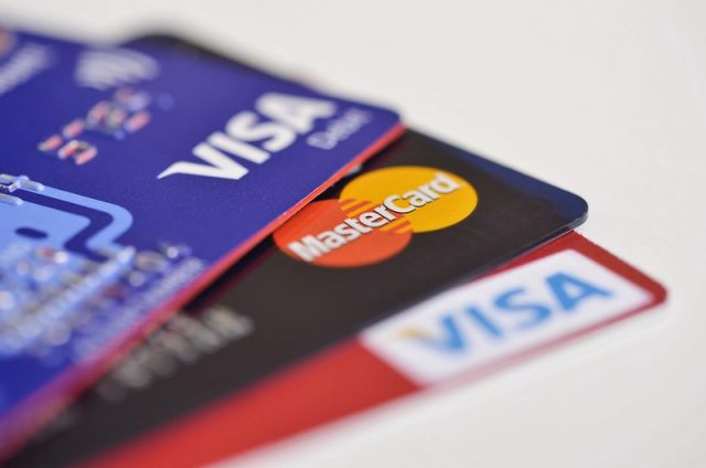 Credit cards are often hit with surcharging. Closeups of Visa and Mastercard cards.