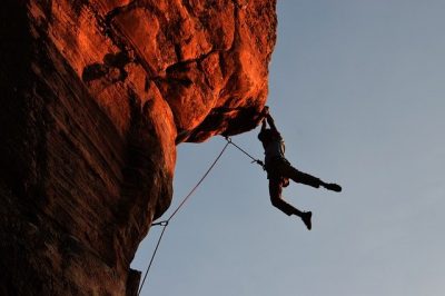 A rock climber suspended over a sheer drop. It looks rather frightening and is a great metaphor for a high-risk merchant.