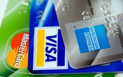 Photo of different credit cards. Each card network charges different interchange fees.